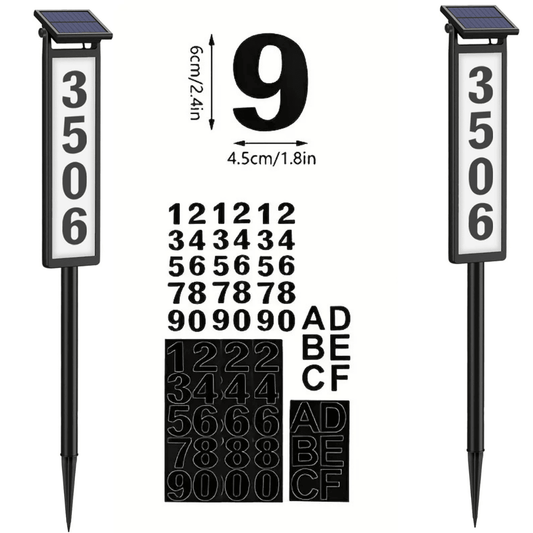 Solar lighted house number signs with customizable numbers and letters, featuring a black number on a white board design, mounted on a stake. The image shows the signs with a numeric keypad and letters for reference.